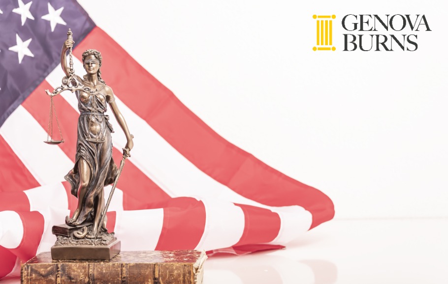 the statue of justice standing on a book with hanging American flag